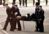 The police officer was stretchered away after collapsing ( Image: REUTERS)