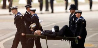 The police officer was stretchered away after collapsing ( Image: REUTERS)