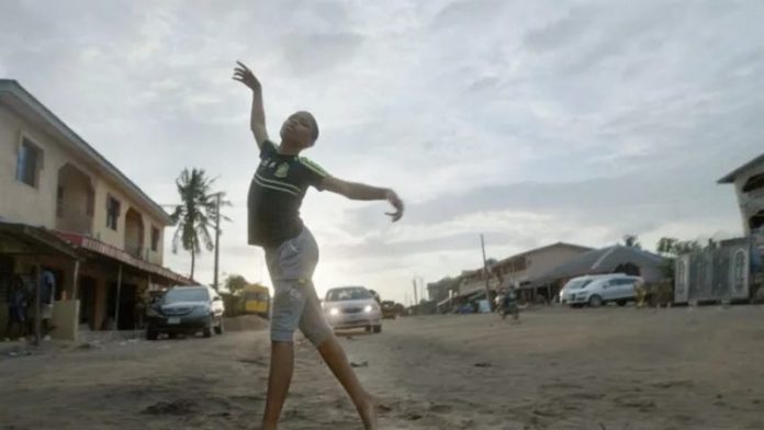 Anthony Madu dancing in the streets of Ajangbadi, Nigeria Disney/Motheo Moeng