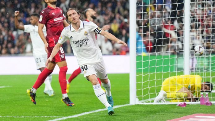 Luka Modric of Real Madrid celebrates after scoring their team's first goal during the LaLiga Santander match between Real Madrid CF and Sevilla FC at Estadio Santiago Bernabeu on October 22, 2022 in Madrid, Spain. (Photo by Angel Martinez/Getty Images) Image credit: Getty Images
