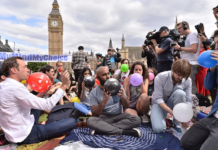 People taking part in a mass inhalation of nitrous oxide outside the Houses of Parliament in protest against the plan to crackdown on legal highs on Aug. 1, 2015 in London, England. Ray Tang/REX Shutterstock