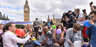 People taking part in a mass inhalation of nitrous oxide outside the Houses of Parliament in protest against the plan to crackdown on legal highs on Aug. 1, 2015 in London, England. Ray Tang/REX Shutterstock