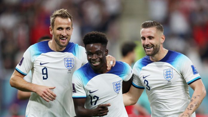 Bukayo Saka of England celebrates with teammates Harry Kane and Luke Shaw after scoring their team's fourth goal during the FIFA World Cup Qatar 2022 Group B match between England and IR Iran Image credit: Getty Images