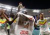 Senegal players applaud fans with a banner of Papa Bouba Diop, on the 2nd anniversary of his death, after their 2-1 victory in the FIFA World Cup Qatar 2022 Group A match between Ecuador and Senegal at Khalifa International Stadium on November 29, 2022 Image credit: Getty Images