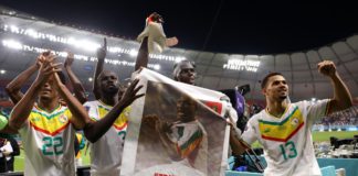 Senegal players applaud fans with a banner of Papa Bouba Diop, on the 2nd anniversary of his death, after their 2-1 victory in the FIFA World Cup Qatar 2022 Group A match between Ecuador and Senegal at Khalifa International Stadium on November 29, 2022 Image credit: Getty Images