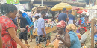 Makola market, Accra: Woman buying yams on a partly cloudy day | photo taken by Adomonline's Dennis K. Adu