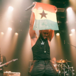 King Promise projects a Ghana flag during one of his 5 Star world tour performances in Europe