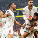 Morocco's Hakim Ziyech is mobbed after scoring the opening goal
