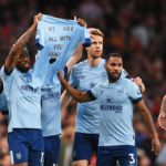 Ivan Toney of Brentford and teammates hold a shirt for former teammate Sergi Canos after scoring the team's first goal during the Premier League match between Arsenal FC and Brentford FC at Emirates Stadium on February 11, 2023 in London, England. Image credit: Getty Images
