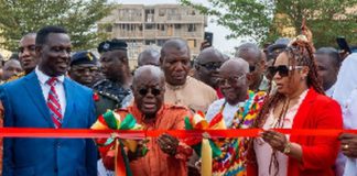 Akuf-Addo flanked by Adwoa Safo and Education Minister as he cuts tape for model school