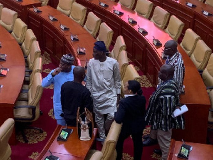 Former Minority leader, Haruna Iddrisu (in brown Khaftan) interacting with colleagues