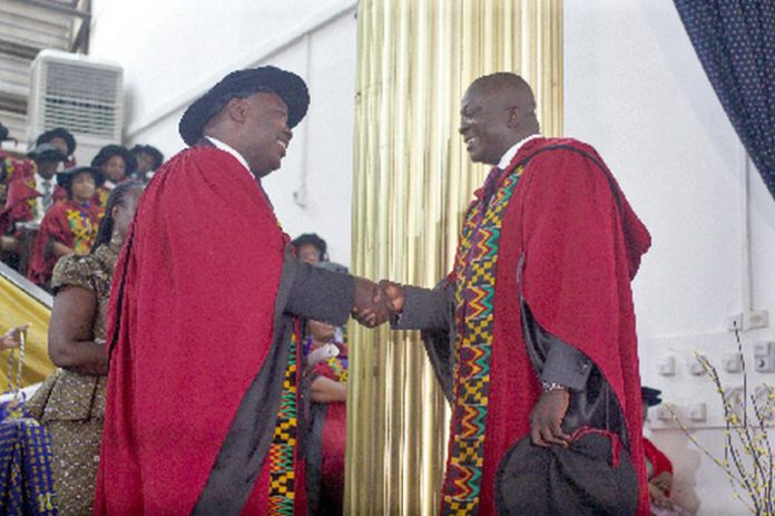 Prof. Robert Darko Osei (left), Dean, School of Graduate Studies, University of Ghana, congratulating Dr Bryan Acheampong, former Minister of State for National Security and Agric Minister designate, during the graduation ceremony. Picture: Maxwell Ocloo