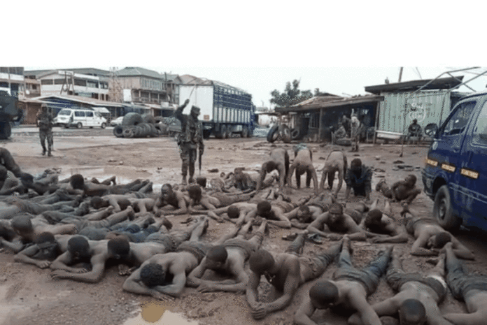 Victims of the military brutalities in Ashaiman herded together, beaten and forced to roll and exercise in mud. Victims of the military brutalities in Ashaiman herded together, beaten and forced to roll and exercise in mud.