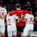 Lisandro Martinez was helped off the pitch by Sevilla's Gonzalo Montiel and Marcos Acuna who are his Argentina team-mates