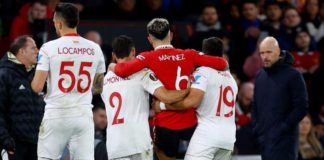 Lisandro Martinez was helped off the pitch by Sevilla's Gonzalo Montiel and Marcos Acuna who are his Argentina team-mates