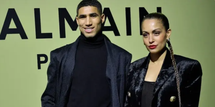 Moroccan and PSG defender Achraf Hakimi (L) and Spanish actress Hiba Abouk pose for a photocall prior to the Balmain Fall-Winter 2022-2023 collection fashion show during the Paris Womenswear Fashion Week, in Paris, on March 2, 2022. (AFP)