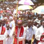 Nyeri Catholic Archbishop Antony Muheria carries a cross as led other faithful in a religious procession to Our Lady of Constanta Cathedral in Nyeri during a past event