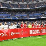 Real Madrid and Rayo Vallecano players held a banner saying "racists out of football" in support of Vinicius Jr before Wednesday's La Liga match at the Bernabeu