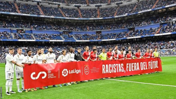 Real Madrid and Rayo Vallecano players held a banner saying Real Madrid and Rayo Vallecano players held a banner saying