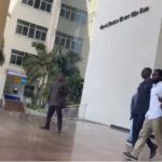 Bismark Ato Foster (in white shirt) being led away from the court by Police