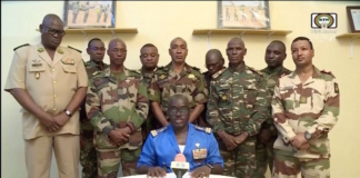 Niger army spokesperson Colonel-Major Amadou Adramane speaks during an appearance on national TV after President Mohamed Bazoum was held in the presidential palace, in Niamey, Niger, July 26, 2023, in this still image taken from video [ORTN via Reuters]