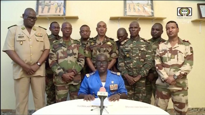 Niger army spokesperson Colonel-Major Amadou Adramane speaks during an appearance on national TV after President Mohamed Bazoum was held in the presidential palace, in Niamey, Niger, July 26, 2023, in this still image taken from video [ORTN via Reuters]