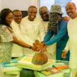 Kwesi Pratt Jnr (fourth left) cuts his 70th birthday cake with wellwishers