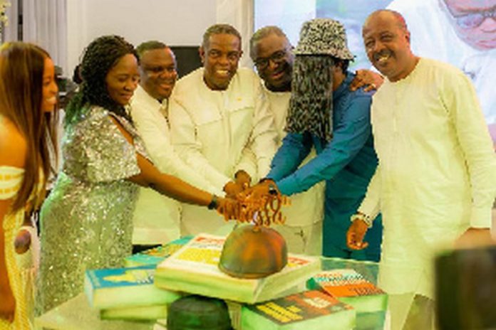 Kwesi Pratt Jnr (fourth left) cuts his 70th birthday cake with wellwishers