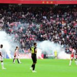 Ajax v Feyenoord abandoned after fans throw flares