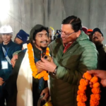 Pushkar Singh Dhami, right, Chief Minister of the state of Uttarakhand, greets a worker rescued from the tunnel in Silkyara, India, Tuesday, November 28, 2023