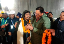 Pushkar Singh Dhami, right, Chief Minister of the state of Uttarakhand, greets a worker rescued from the tunnel in Silkyara, India, Tuesday, November 28, 2023