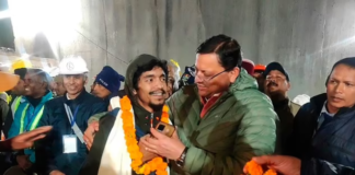 Pushkar Singh Dhami, right, Chief Minister of the state of Uttarakhand, greets a worker rescued from the tunnel in Silkyara, India, Tuesday, November 28, 2023