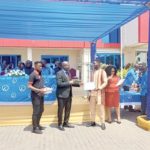 Prof. Alex Dodoo (2nd from left), Director-General, GSA, presenting a certificate to Atteh Adamtey, a certified electrical wiring professional, at the graduation ceremony