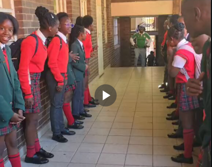 South African students welcome their Nigerian Teacher with a guard of honour, after Nigeria beat South Africa in the AFCON.