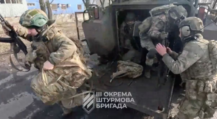 [1/6] Ukrainian soldiers get out of a military vehicle in a location given as Avdiivka, Donetsk Region, Ukraine, in this screen grab taken from a video released February 17, 2024. 3Rd Assault Brigade/Handout via REUTERS Purchase Licensing Rights