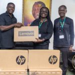 Dr Gideon Boako, spokesperson for the Vice- President (left) presenting one of the laptops to Prof Rita Akosua Dickson, Vice-Chancellor of the KNUST (second from right). With them is the Registrar of the school