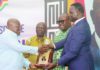 President Akufo-Addo (left) receiving a citation from Dr Yaw Adutwum after the launch of the NSS Policy in Accra. With them are Osei Assibey Antwi (2nd from left) and Nii Odoi Tetteyfio, Board Chairman, NSS. Picture: SAMUEL TEI ADANO