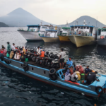 People travel on a wooden boat with motor scooters to Tidore Island ahead of Eid al-Fitr, which marks the end of the Muslim fasting month of Ramadan, at Bastiong port in Ternate, North Maluku, on 7 April 2024. Azzam Risqullah / AFP