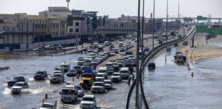 Vehicles drive through floodwater caused by heavy rain in Dubai on Thursday. Christopher Pike/AP