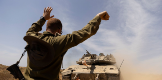 An Israeli soldier directed a tank near the border with the southern Gaza Strip on Thursday. AMIR LEVY/GETTY IMAGES