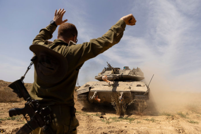 An Israeli soldier directed a tank near the border with the southern Gaza Strip on Thursday. AMIR LEVY/GETTY IMAGES