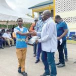 Dr Bawumia presenting a tablet to one of the students