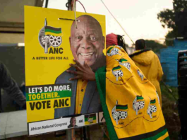 African National Congress (ANC) polling agents set up a tent decorated with party paraphernalia outside a polling station in Umlazi on May 29, during South Africa's general election. Zinyange Auntony/AFP via Getty Images