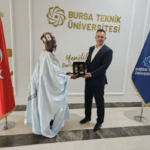 Ya-Na Abukari II receiving a souvenir from Prof Dr. Naci Caglar, VC of Bursa Technical University in Bursa, Turkey after a co-operation meeting.