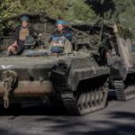 Ukrainian servicemen ride an armoured personnel carrier, near the Russian border in Sumy region, Ukraine, on Wednesday. Viacheslav Ratynskyi/Reuters