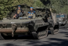 Ukrainian servicemen ride an armoured personnel carrier, near the Russian border in Sumy region, Ukraine, on Wednesday. Viacheslav Ratynskyi/Reuters