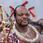 King Mswati III, who took the throne in 1986, arrives in ceremonial dress for the annual reed dance
