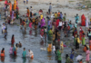 Hindustan Times via Getty Images The annual Jivitputrika festival is celebrated in several states in north-eastern India. In this 2020 photo, women and children are seen bathing in a river in the Uttar Pradesh state.