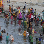 Hindustan Times via Getty Images The annual Jivitputrika festival is celebrated in several states in north-eastern India. In this 2020 photo, women and children are seen bathing in a river in the Uttar Pradesh state.