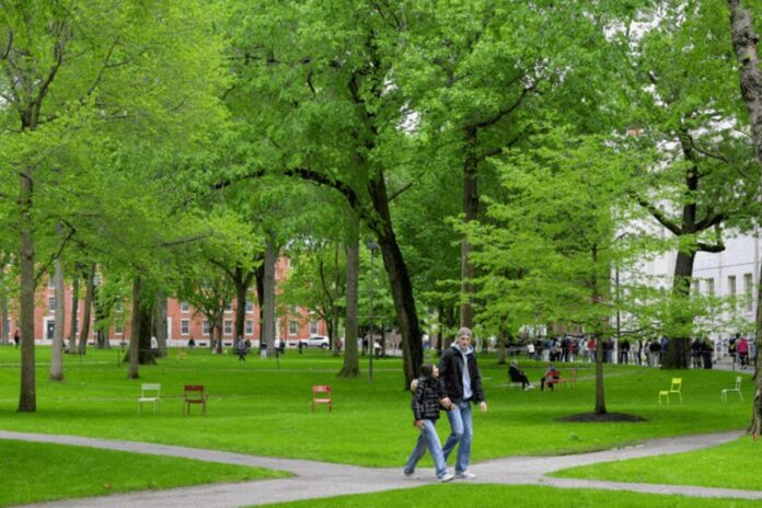 Students walk on the campus of Harvard University in Cambridge, Massachusetts,